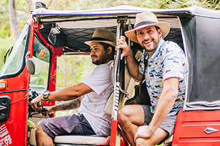 Two men in a car sporting the Carkella Palm Beach Fedora sun hats