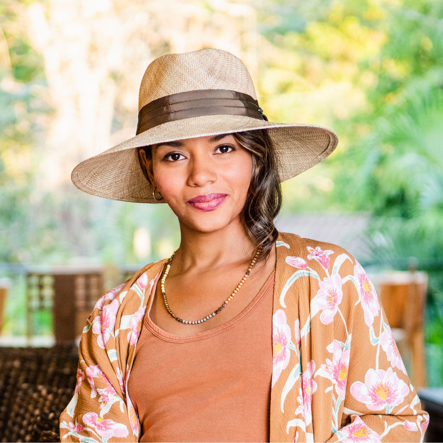Woman wearing a big wide brim Charlotte sun hat by Wallaroo, Natural
