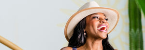 Woman smiling while wearing Lauren UPf 50 sun hat, featuring a wide brim