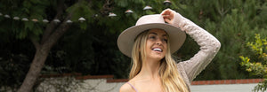 Woman wearing a wide brim sun hat outside 