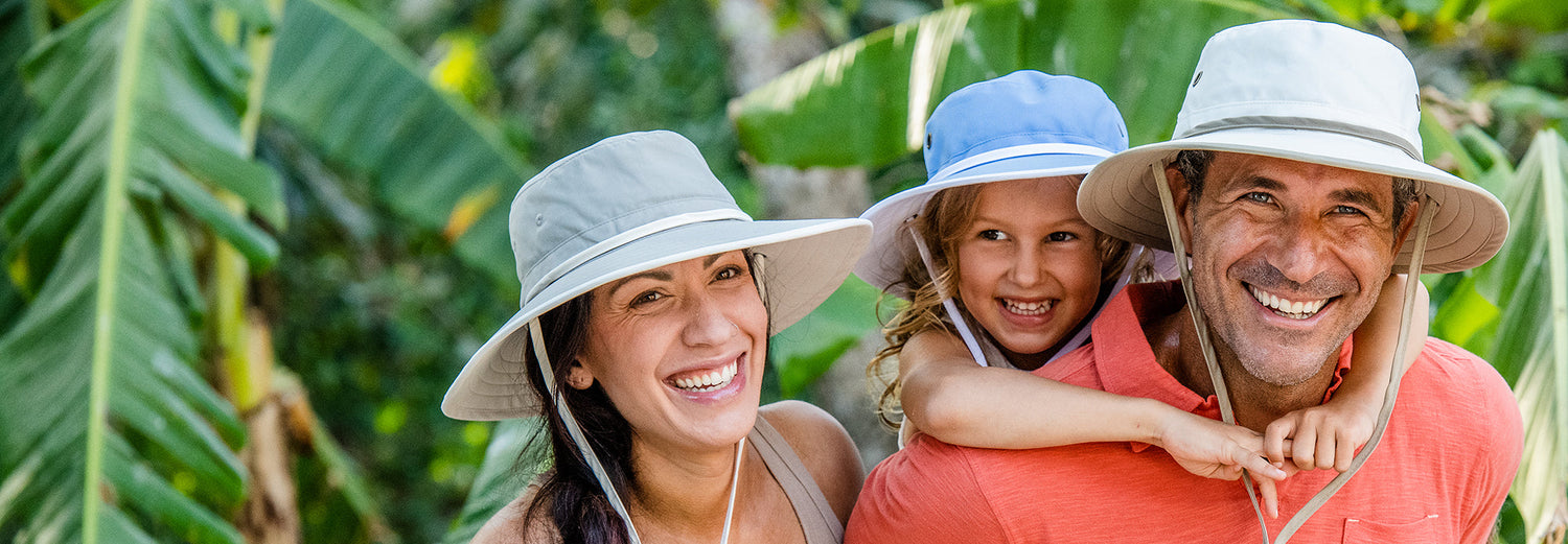 Family smiling while wearing summer beach hats by Wallaroo