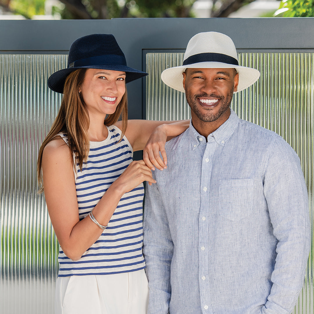 Man and woman standing together outdoors, both wearing the Carkella Fairway fedora packable sun hats.