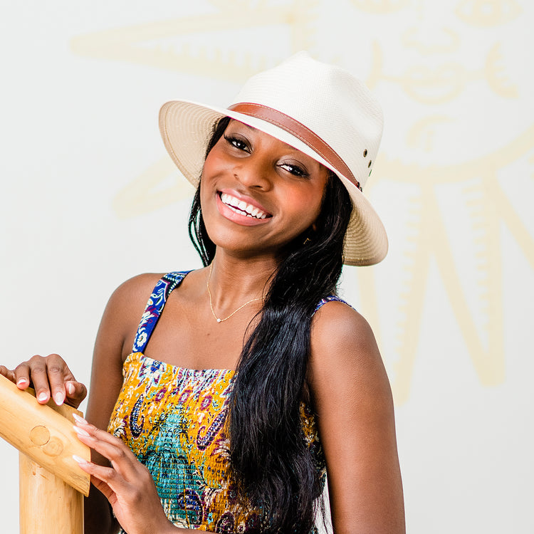 Woman smiling wearing the UPF Natural Avery fedora sun protection hat by wallaroo