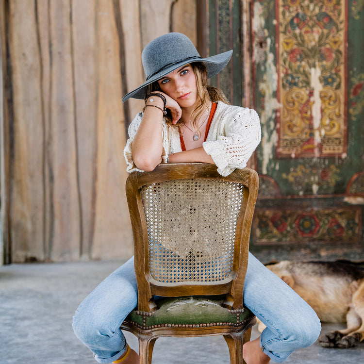 Woman shaded by the Wallaroo Women’s Victoria Sun Hat, designed for cold days and fashionable fall and winter outings, Grey