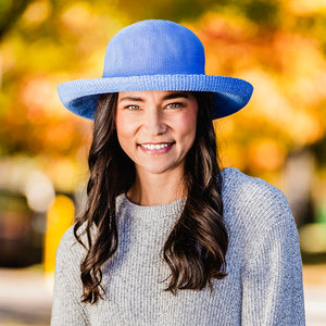 Woman in fall/winter clothing wearing a UPF sun hat by Wallaroo