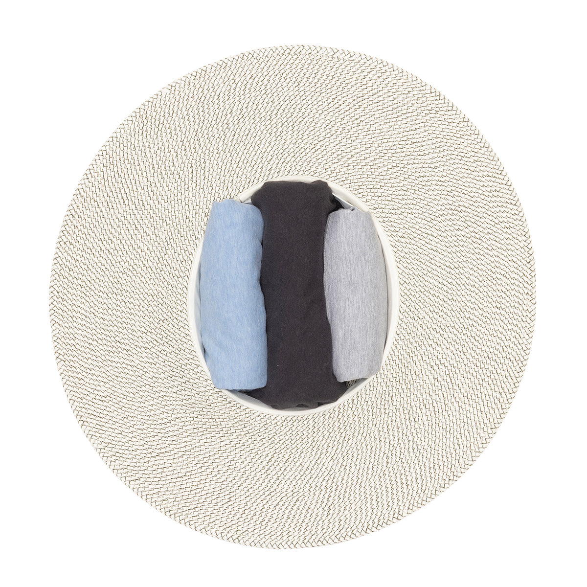 A top-down view of the Carkella Kerrigan UPF 50+ fedora hat in ivory olive with a dark olive green band around the crown, showing the 'stuff it' packing method with three rolled fabric inserts in light blue, dark charcoal, and light gray inside the crown opening, set against a plain white background.