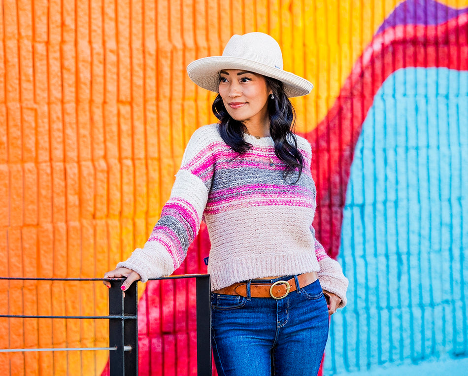 Woman standing outside while wearing a big wide brim sun hat by Carkella