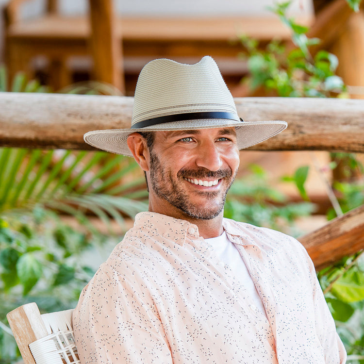 Man enjoying the outdoors with the Wallaroo Carter Fedora, combining a chic look and sun protection, Ivory/Stone