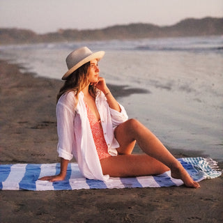 Woman on the beach wearing a ladies' summer sun hat by Wallaroo
