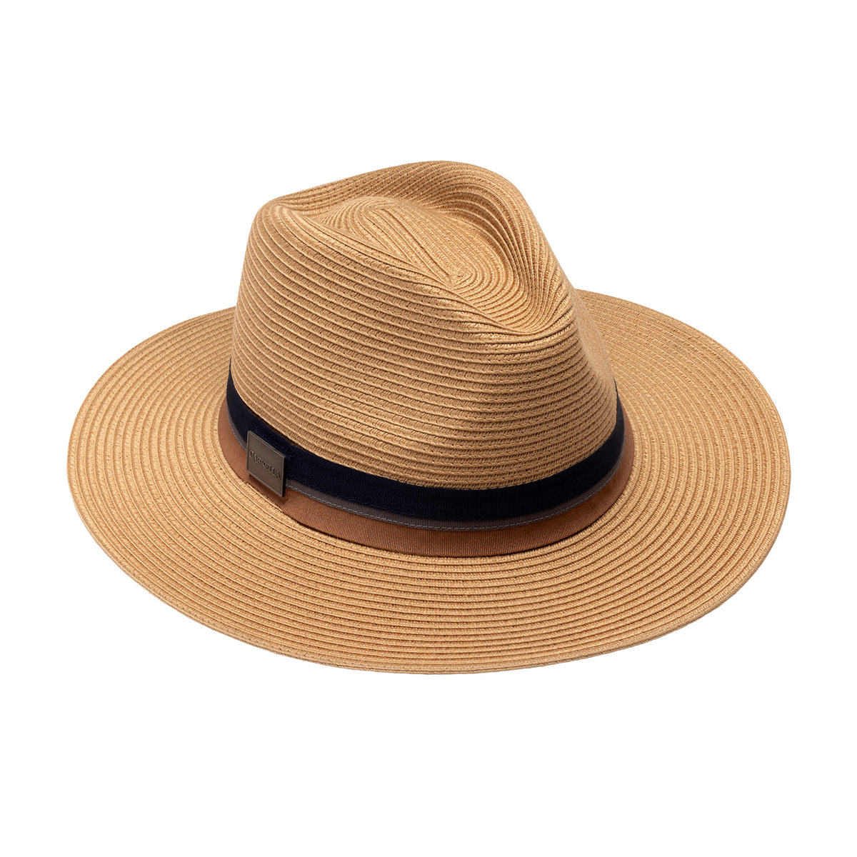 The Carkella Colin fedora hat in camel, featuring a woven straw texture, a brown and dark blue ribbon band with a magnetic emblem on the right-hand side of the crown, and a wide flat brim, isolated against a white background.   