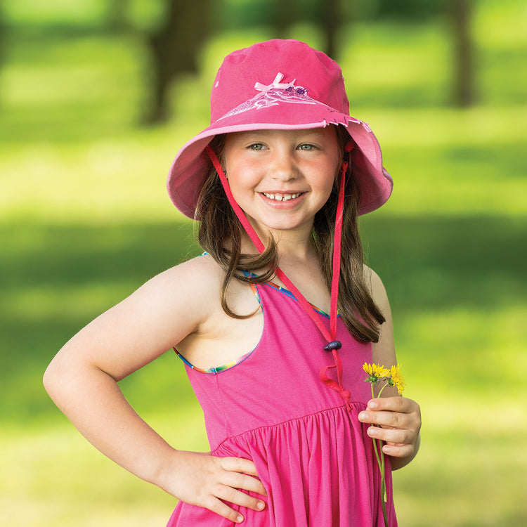 Little adventurer on a camping trip, sporting the Wallaroo Children's cartoon Crocodile sun hat, crafted for durability, UPF 50+ sun protection, and outdoor exploration, Pink