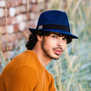 Man enjoying a sunny day wearing the Carkella Del Mar Trilby Fedora Sun Hat, offering breathable comfort and stylish sun protection for long summer days outdoors, 'Mixed Navy'