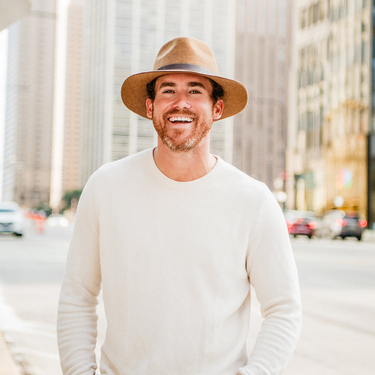 Man exploring a historic city square in the Wallaroo Durango Wide Brim Fedora, a perfect accessory for sun protection and urban style, Chestnut