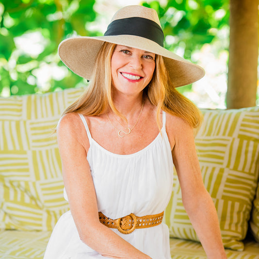 Woman wearing a ladies big wide brim summer sun hat by Wallaroo