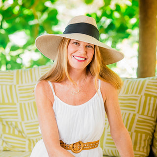 Woman wearing a ladies big wide brim summer sun hat by Wallaroo, White Beige w/black scarf