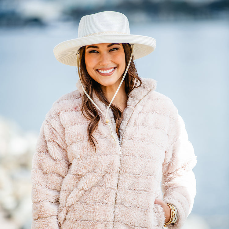 woman wearing a wide brim sun hat with chinstrap