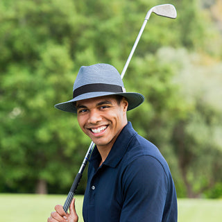 Man wearing the Carkella Fairway Fedora Sun Hat while playing golf, designed to keep the sun at bay during outdoor sports and leisure activities, Blue