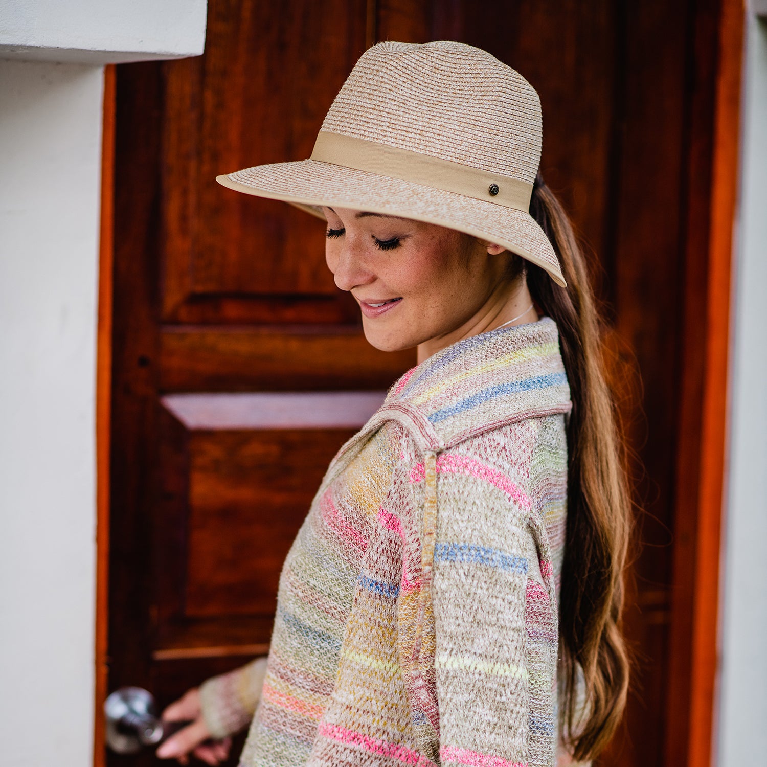 Woman wearing a ladies' ponytail summer sun hat by Wallaroo, Beige