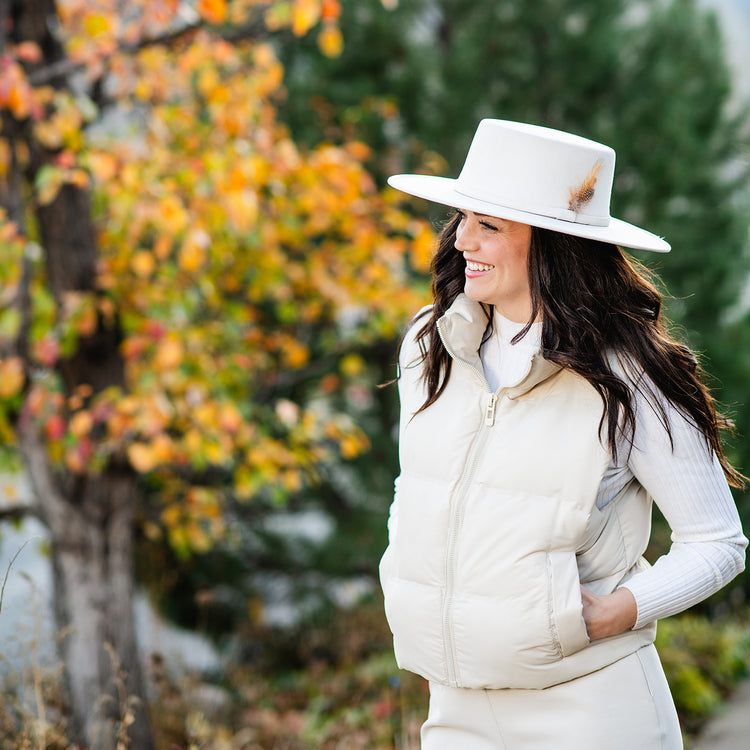 Woman posing for photos on a sunny day while wearing the Wallaroo Indo Fedora Hat, offering trendy wide-brim sun protection and a modern aesthetic for memorable urban moments, Pearl