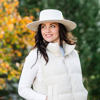 Woman strolling through a sunny city park in the Wallaroo Indo Fedora Hat, showcasing its wide brim, stiff structure, and chic design for active urban lifestyles, Pearl