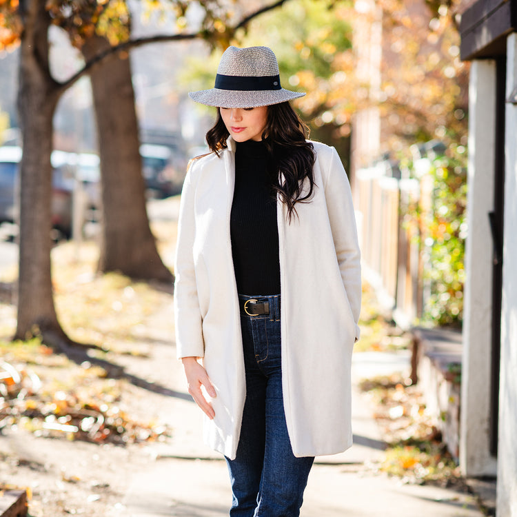 Woman wearing a fedora style winter sun hat, Mixed Black