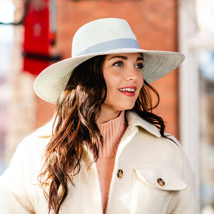 Woman in winter clothes wearing a fedora style big wide brim sun hat for  ladies