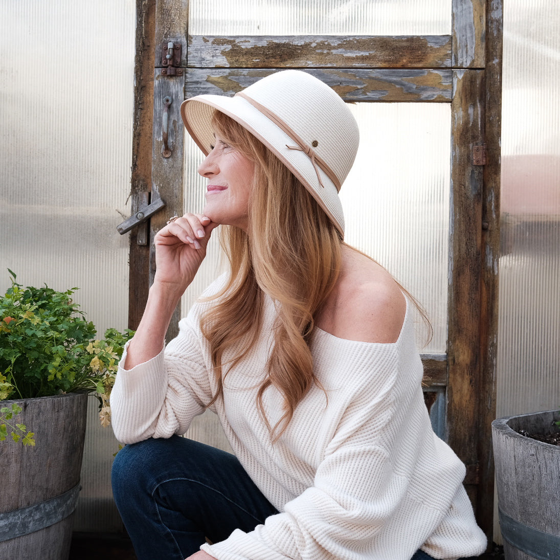 Actress Jane Seymour wearing the Lady Brett cloche sun hat in garden, Ivory