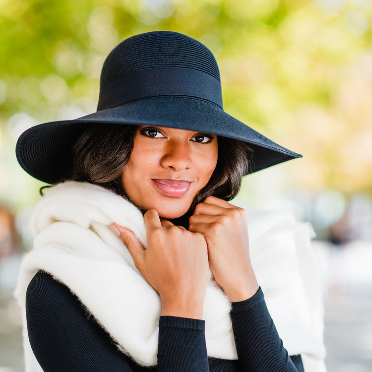 Woman wearing the Wallaroo Jane Seymour Margot sun hat, offering dramatic style and UPF 50+ sun protection, Black