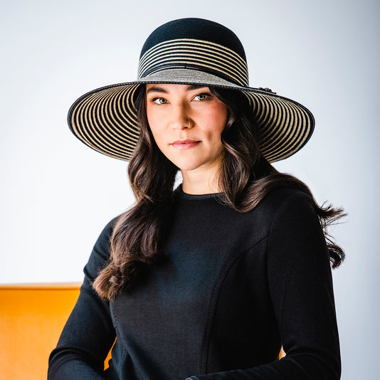 Woman in fall/winter clothing wearing a big wide brim sun hat by Wallaroo