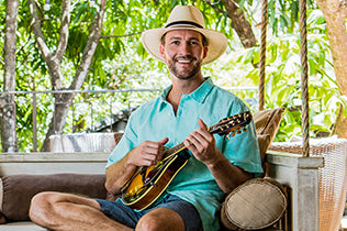 Man in playing an instrument while wearing the Turner fedora sun hat by Wallaroo