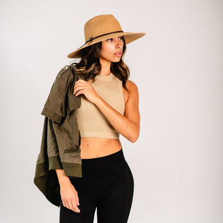 Woman posing with the Wallaroo Montecito sun hat shielding her from the sun while she enjoys her new urban adventure, Camel