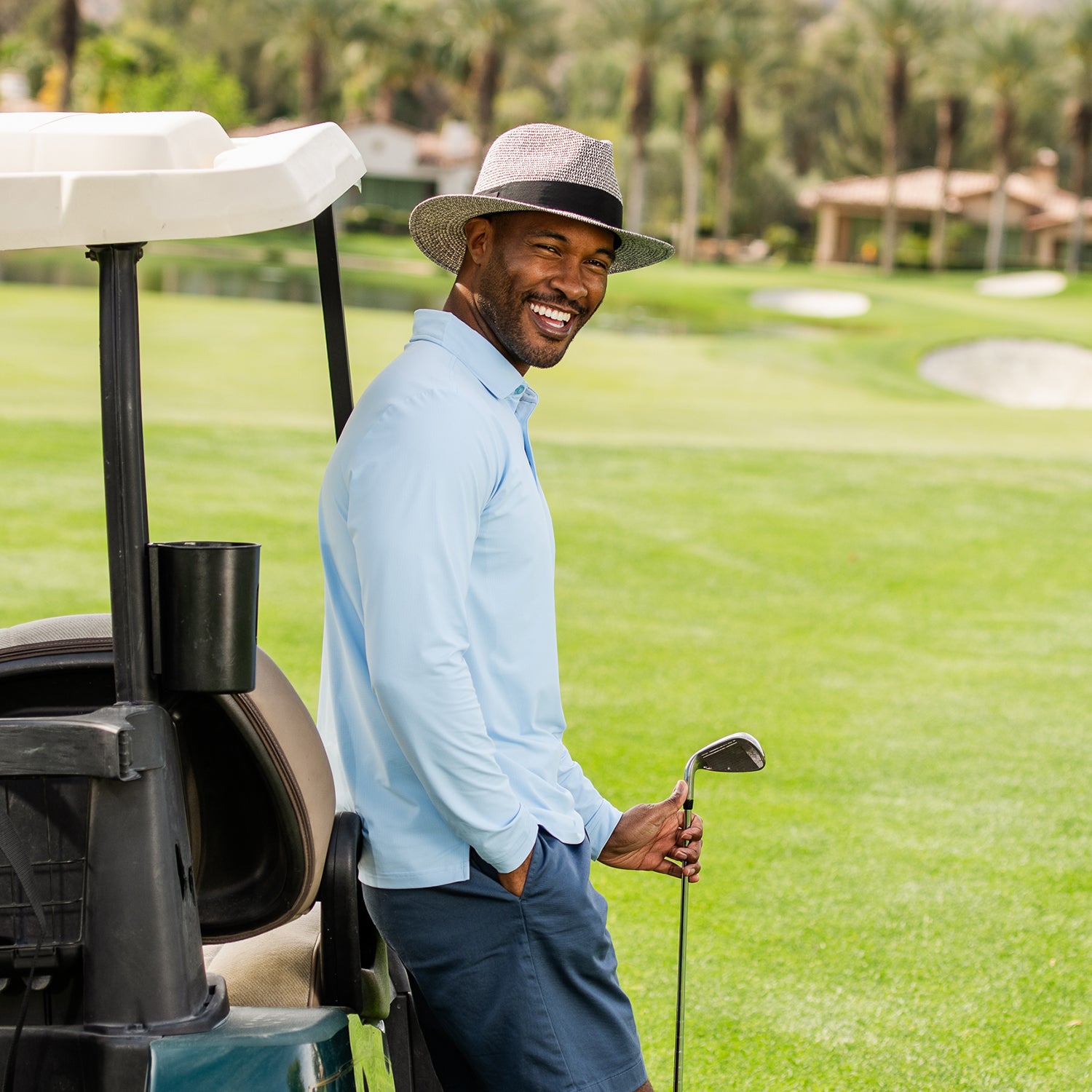 Man wearing Carkella Newhall fedora with a golf club standing next to a golf cart on a golf course, Mixed Black