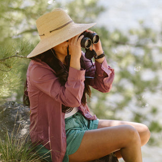 Woman outside wearing a wide brim sun hat by Wallaroo