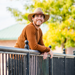 Man wearing the Wallaroo Outback wide brim sun hat, with UPF 50+ protection and made from natural fibers to keep him comfortable, Brown