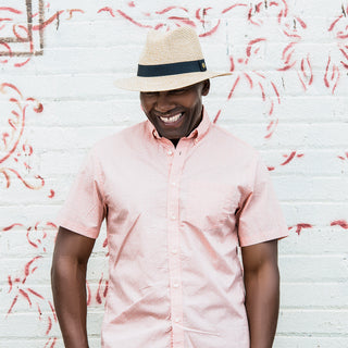 Man Wearing a Mixed Beige Packable Unisex Fedora Style Palm Beach UPF Sun Hat in Beige from Wallaroo