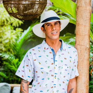 Man enjoying an exotic getaway on a hot day, wearing the Carkella Palm Beach Panama Fedora Sun Hat, wide brim and UPF 50+ for all-day breathable sun protection, White