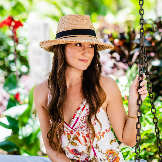 Woman outside wearing a beach straw sun hat by Wallaroo