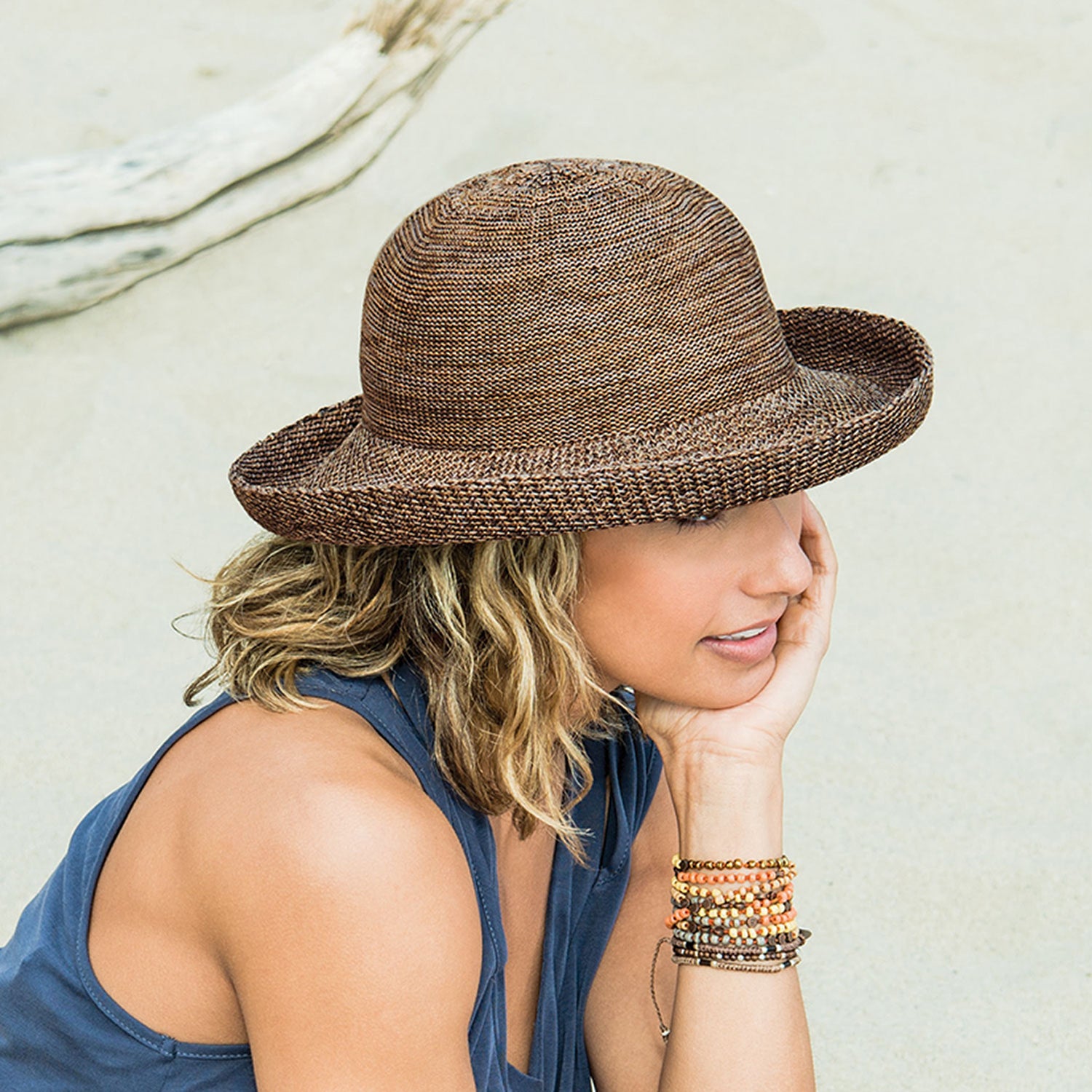 woman on the beach wearing victoria sun hat by Wallaroo with an upturned brim