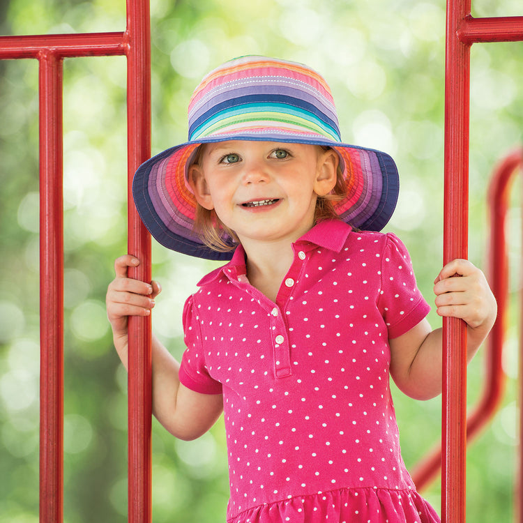 Girl Wearing a Packable Kid's Petite Nantucket UPF Sun Hat in Rainbow Tones from Wallaroo