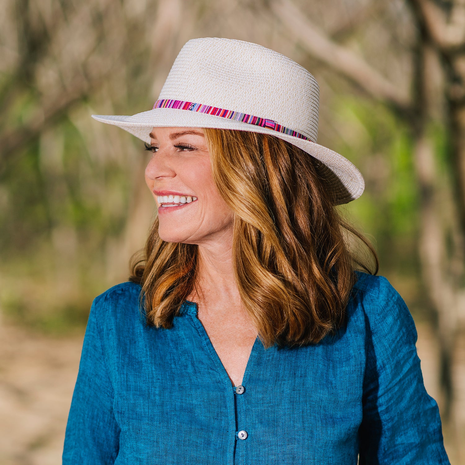 Woman outside wearing the petite sedona beach sun hat with UPF 50+ rating, Natural