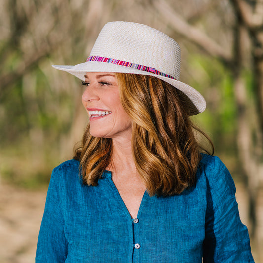 Woman outside wearing the petite sedona beach sun hat with UPF 50+ rating, Natural