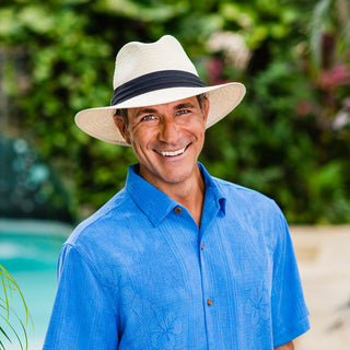 Man exploring on a hot day, wearing the Carkella Portland Panama Fedora Sun Hat, wide brim and UPF 50+ for all-day breathable sun protection, Ivory