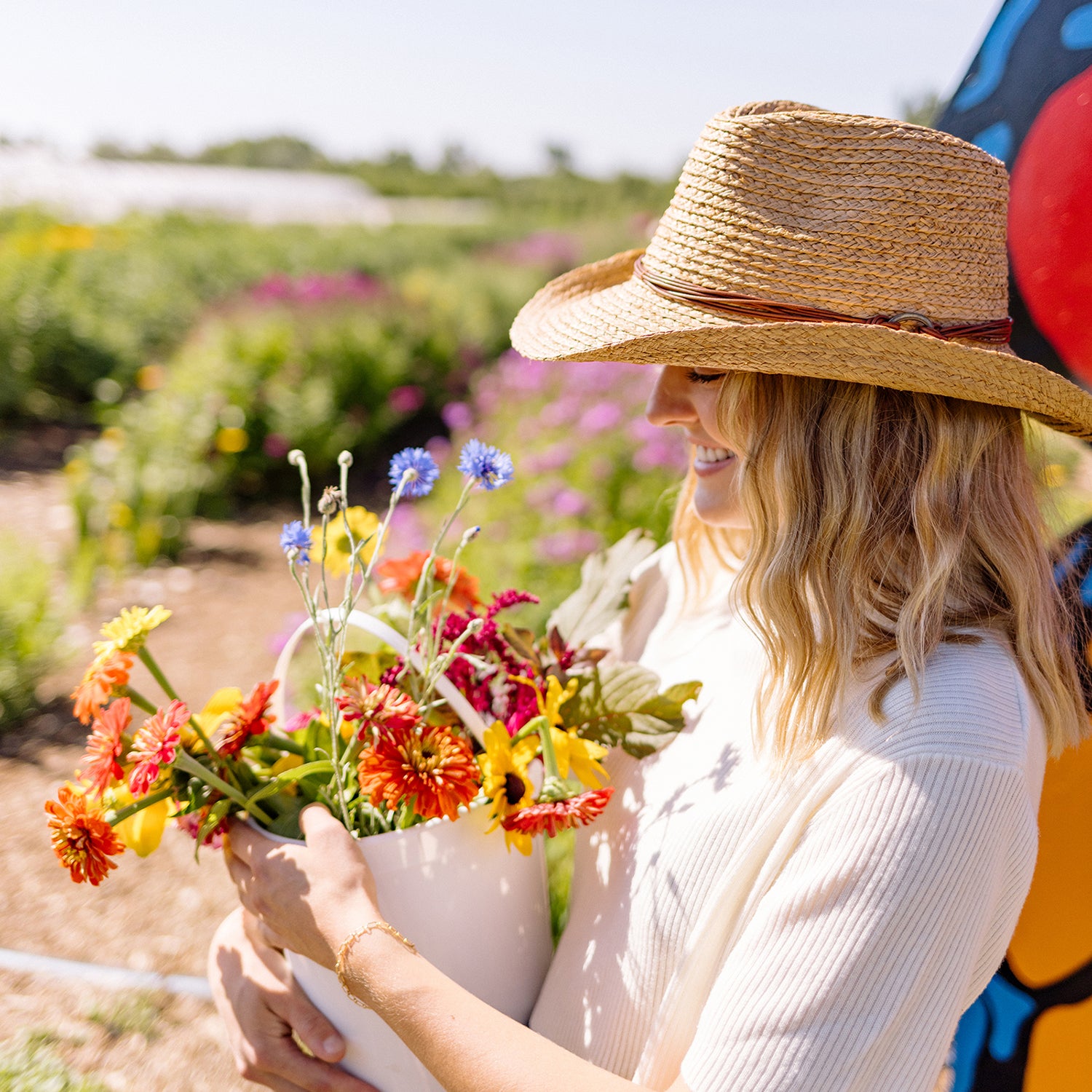 Cowgirl-style woman enjoying a sunny day, wearing the Wallaroo Women’s Quinn Wide Brim Hat, perfect for western summer elegance, Camel