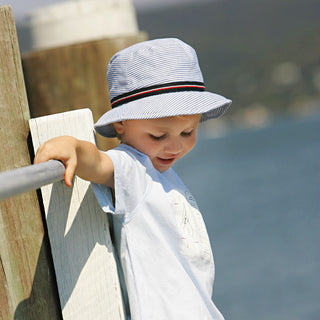 Unisex Kids Bucket Boone sun hat by Wallaroo, featuring a casual playful style, UV protection, and travel-friendly, lightweight construction, spf 50, Blue Stripes