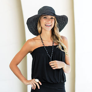 Woman enjoying a sunny day, protected by the Wallaroo Scrunchie Wide Brim Sun Hat, designed for spring and summer days, 'Black/White Dots'