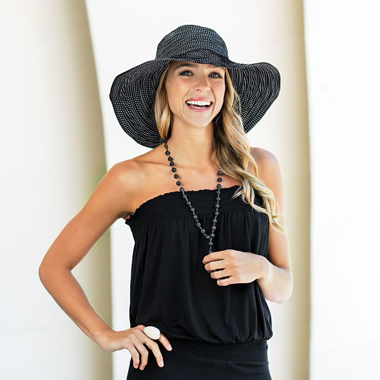 Woman enjoying a sunny day, protected by the Wallaroo Scrunchie Wide Brim Sun Hat, designed for spring and summer days, 'Black/White Dots'