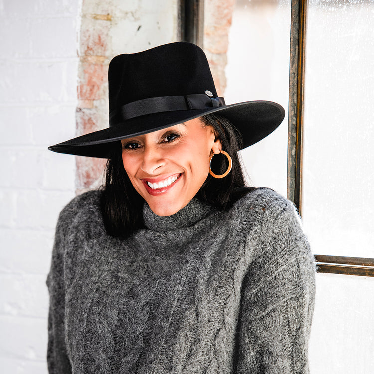 Woman Wearing Unisex Felt Wide Brim Fedora Style Sloan UPF Sun Hat in Black from Wallaroo