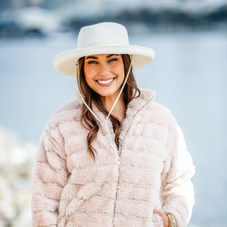 woman wearing a wide brim sun hat with chinstrap, Ivory