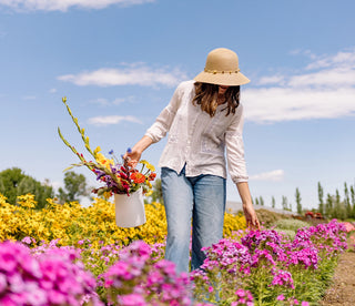 Woman gardening while wearing a bucket style sun hat by Wallaroo