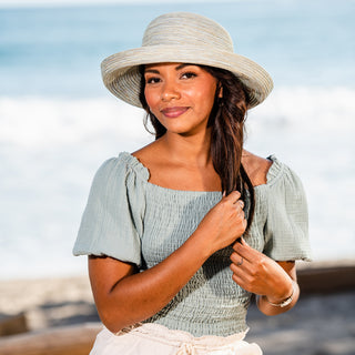 Woman wearing a wide brim summer beach hat by Wallaroo